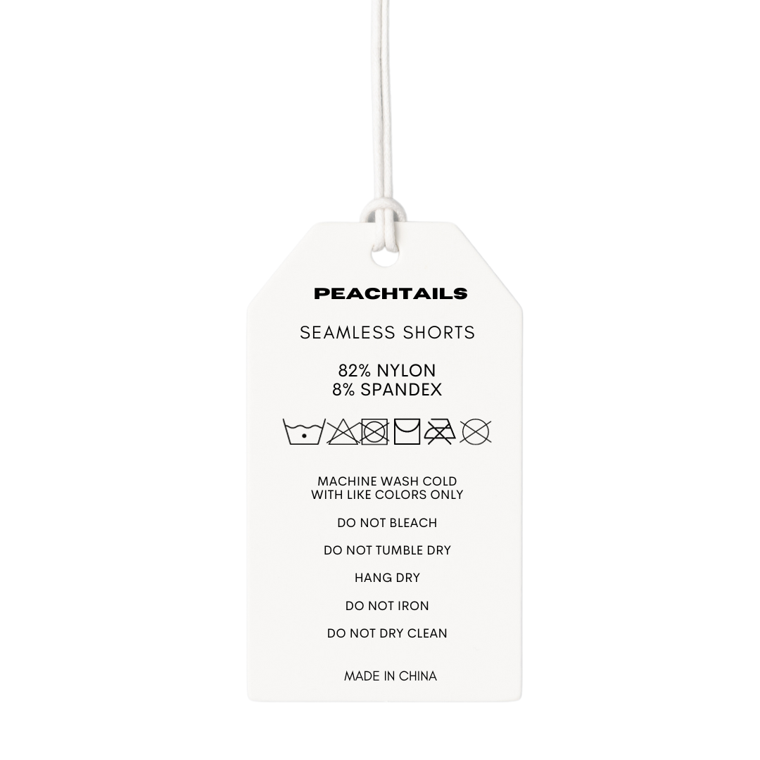 The image is of a white clothing tag with a string attachment, displaying the "PEACHTAILS" brand name at the top. Below, it reads "SEAMLESS SHORTS," followed by the fabric composition "82% NYLON 8% SPANDEX." Care symbols indicate machine wash cold with like colors only, no bleach, no tumble dry, hang dry, no iron, and do not dry clean. At the bottom, it states "MADE IN CHINA."